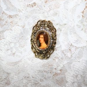 Antique brooch with painting of woman